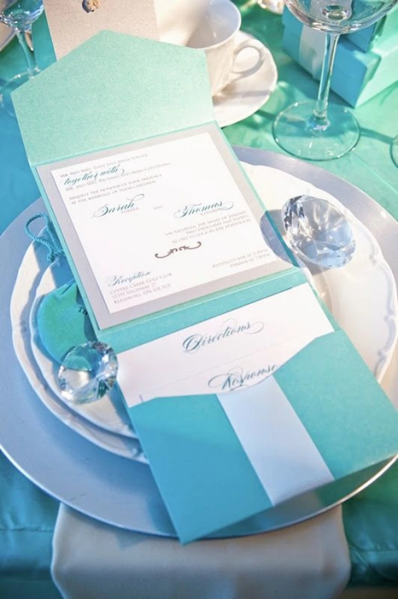 Thiệp cưới màu xanh Tiffany đặt trên bàn tiệc cưới sang trọng và tinh tế