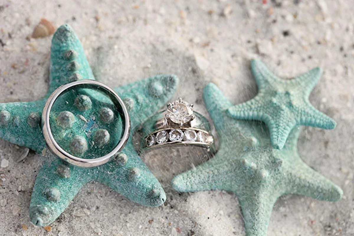 Nhẫn cưới đặt trên sao biển theo concept đám cưới biển tông xanh Tiffany