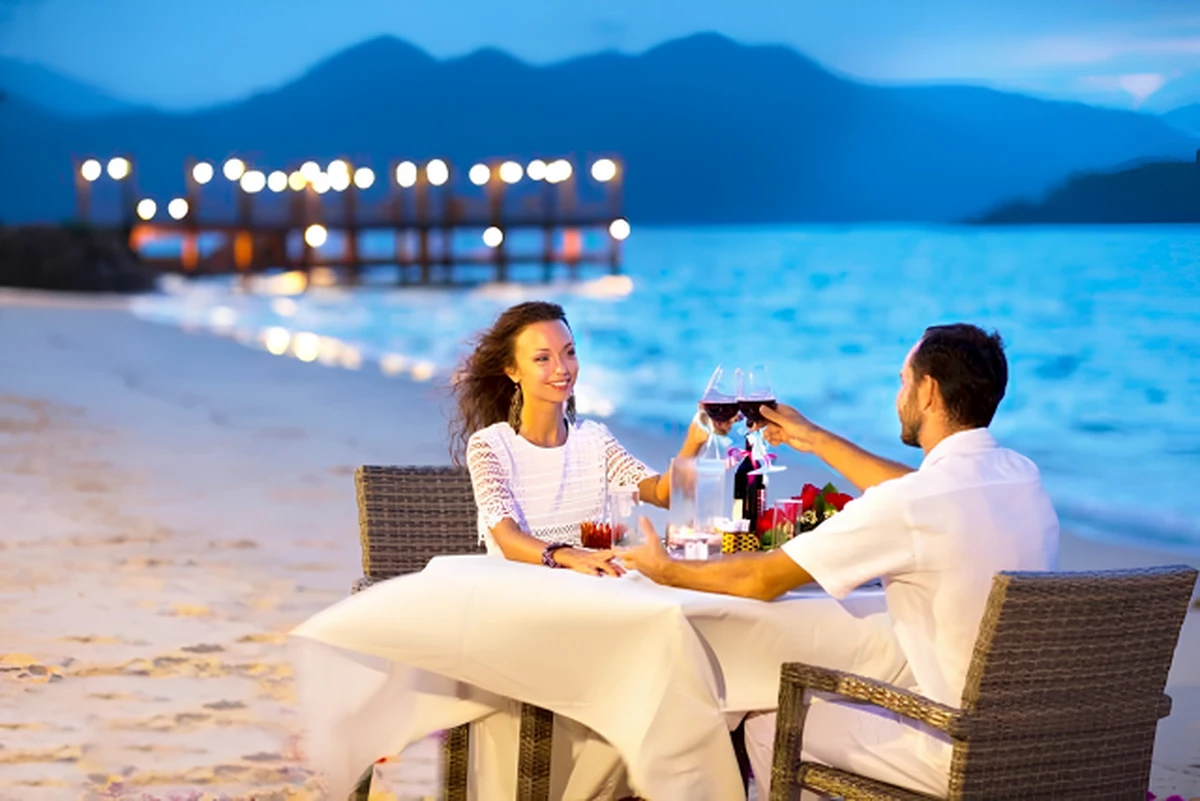 Bữa tối lãng mạn bên bờ biển với ánh nến lung linh và rượu vang hảo hạng